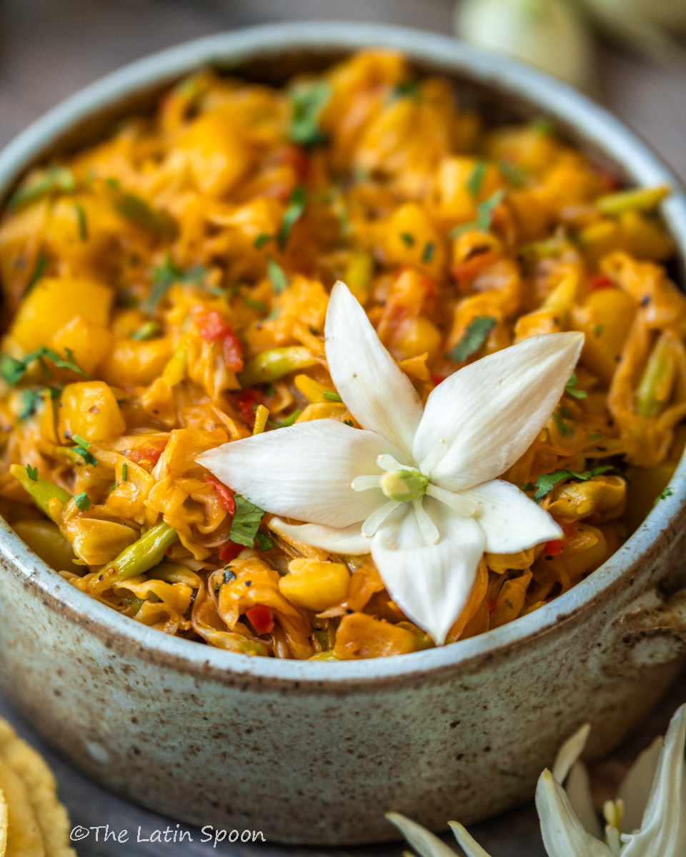 Traditional Costa Rican picadillo with yucca flowers and potatoes, beautifully served in a bowl and topped with a blooming yucca flower