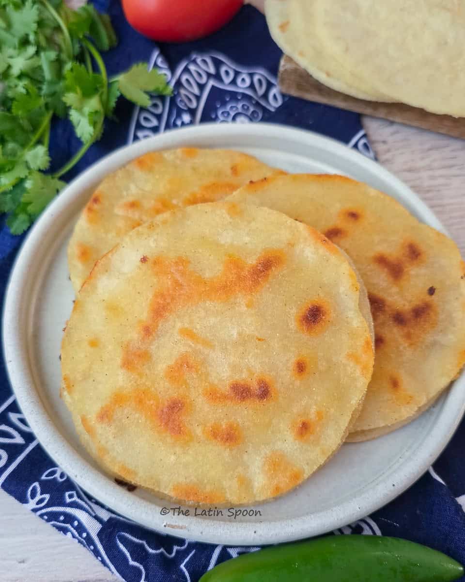 A plate with three "Costa Rican prensadas" placed on a traditional cloth