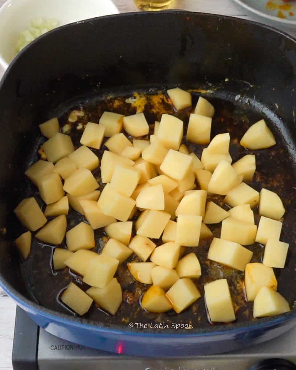 In the dutch oven small cubes of potato
