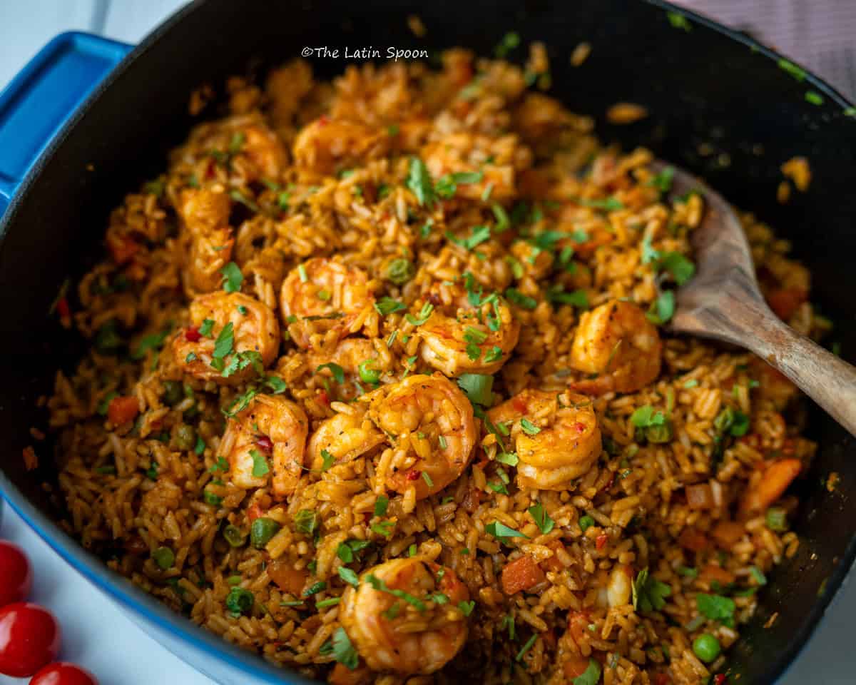 Blue pot filled with arroz con camarones, viewed from above.