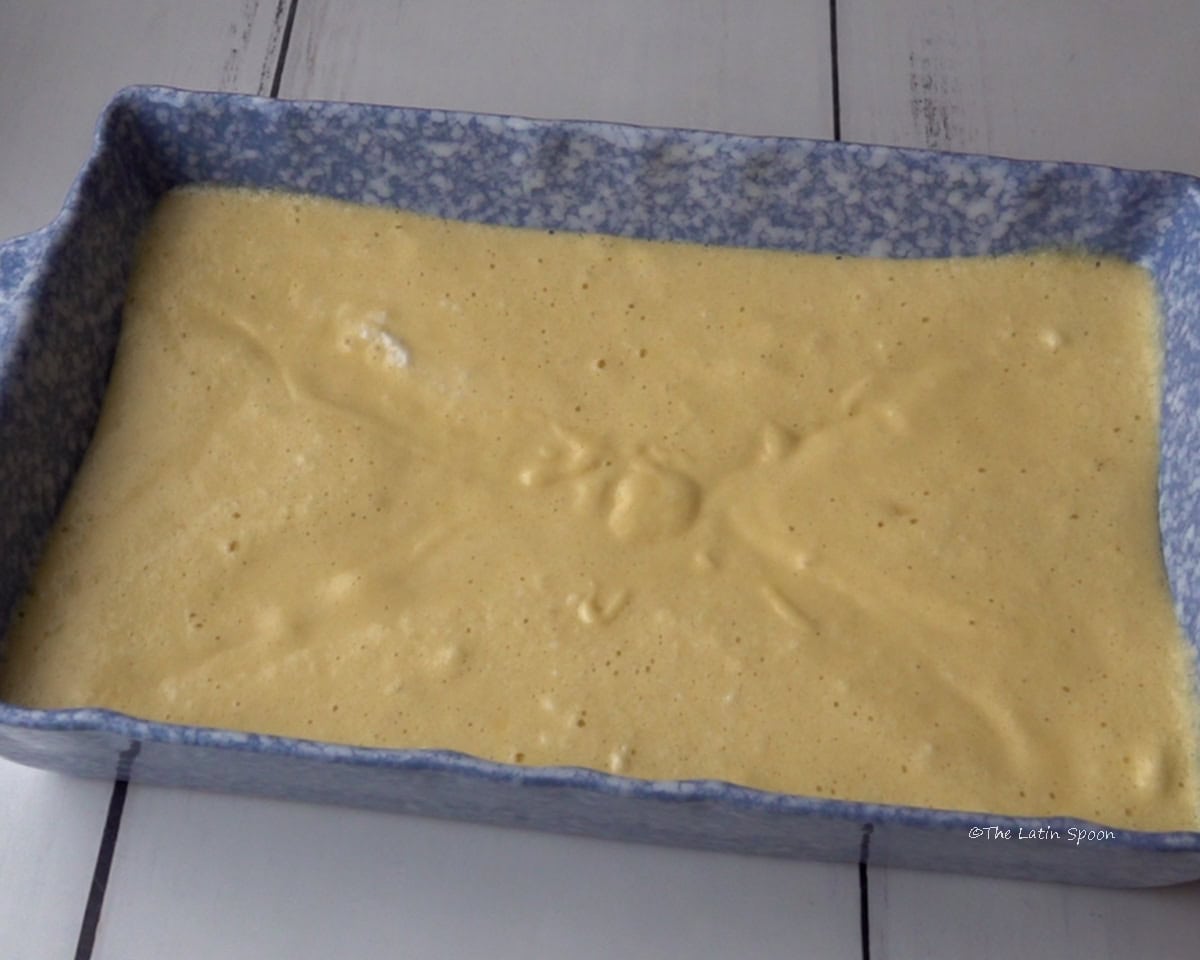 A baking dish filled with the uncooked cake batter.